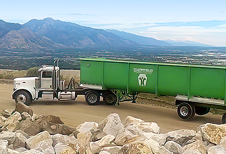 Green recycling truck on mountain